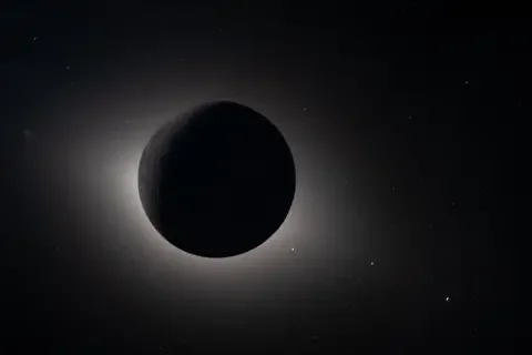 NASA A dark circle in th eblackness of space with the Sun's atmosphere shimmering around its edges.